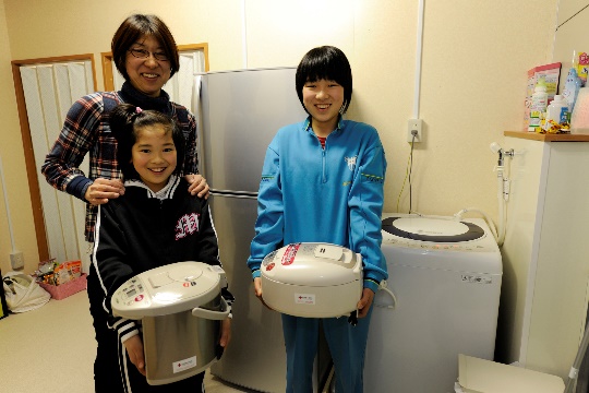 A family receiving an electrical household appliances package